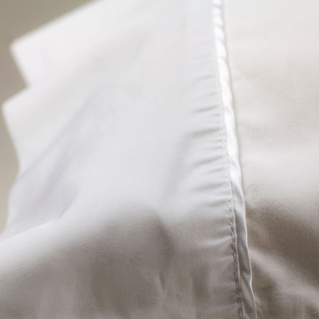 Nollapelli single white pillowcase close up on white satin trim