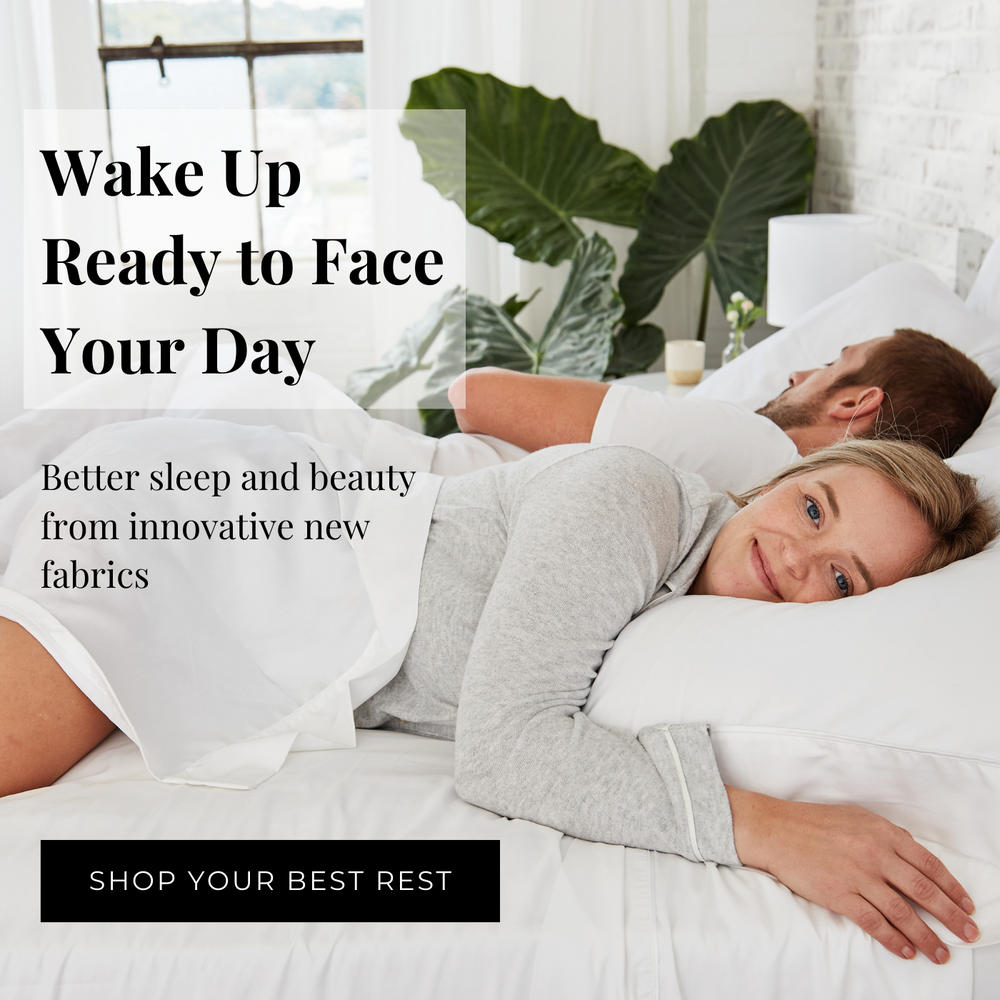 Pretty couple in a white bed waking up happy
